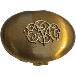 vintage Germaine Monteil goldtone oval compact with raised filigree design